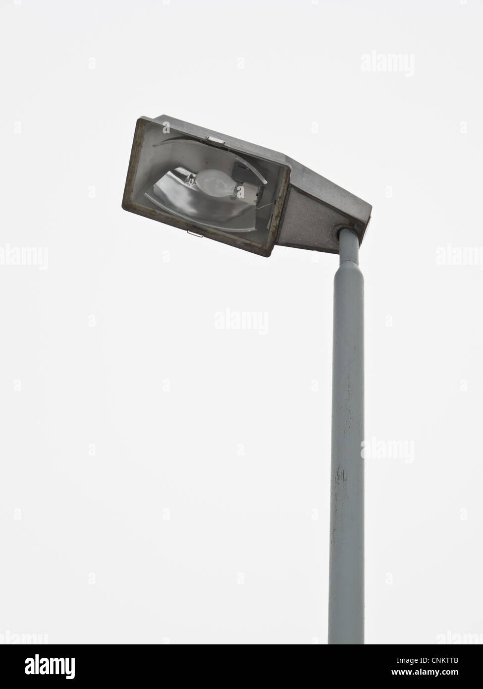 A switched off street light with a milky sky in the background. Stock Photo
