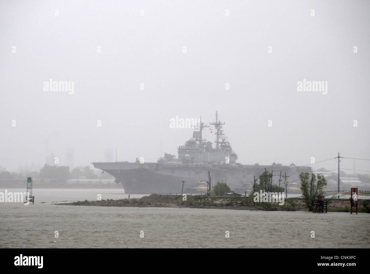 With Algiers Point in the foreground, the multipurpose amphibious assault ship USS Wasp (LHD 1) arrives for The War of 1812 Bicentennial Commemoration in New Orleans. The event is part of a series of city visits by the Navy, Coast Guard, Marine Corps and Operation Sail beginning in April 2012 and concluding in 2015. New Orleans is the first and the last city visit in the series. Stock Photo