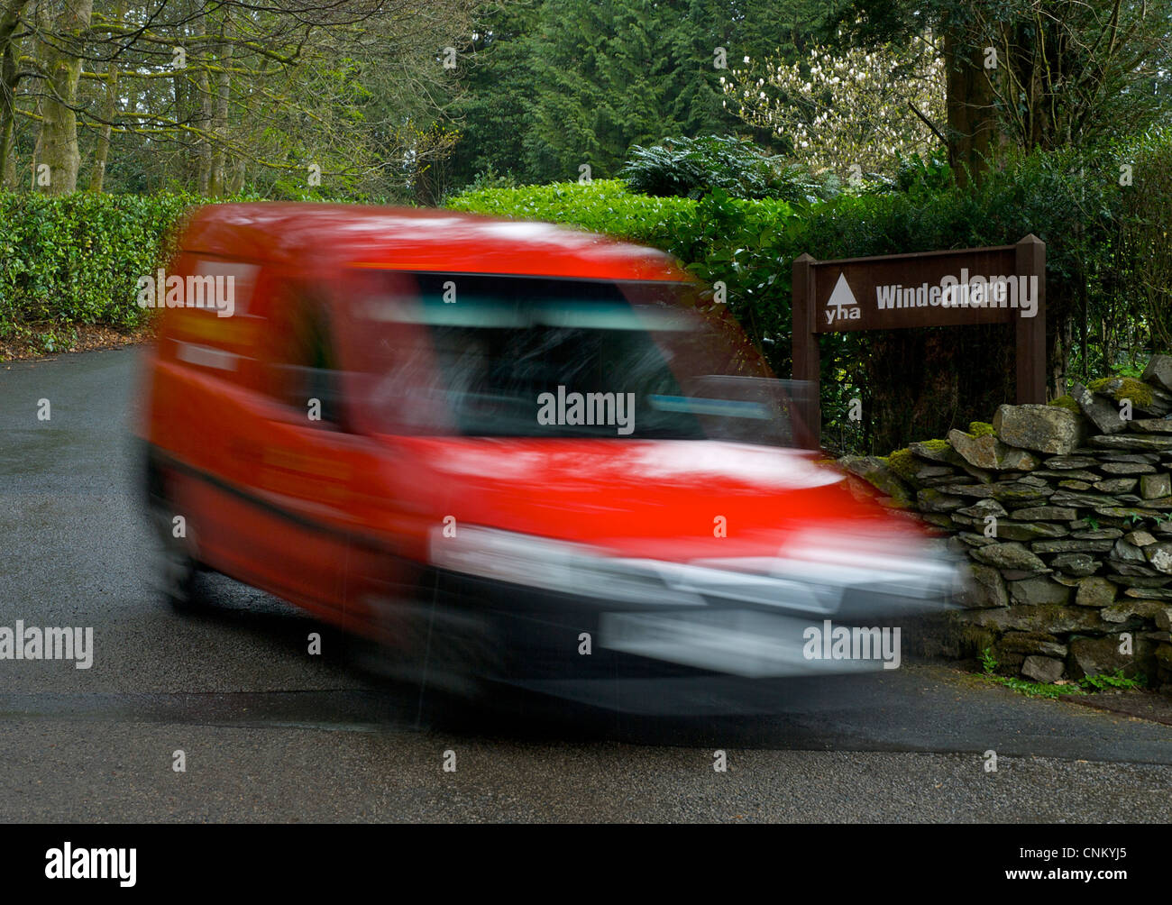 Blurred Royal Mail van delivering to Windermere Youth Hostel, Troutbeck, Lake District National Park, Cumbria, England UK Stock Photo