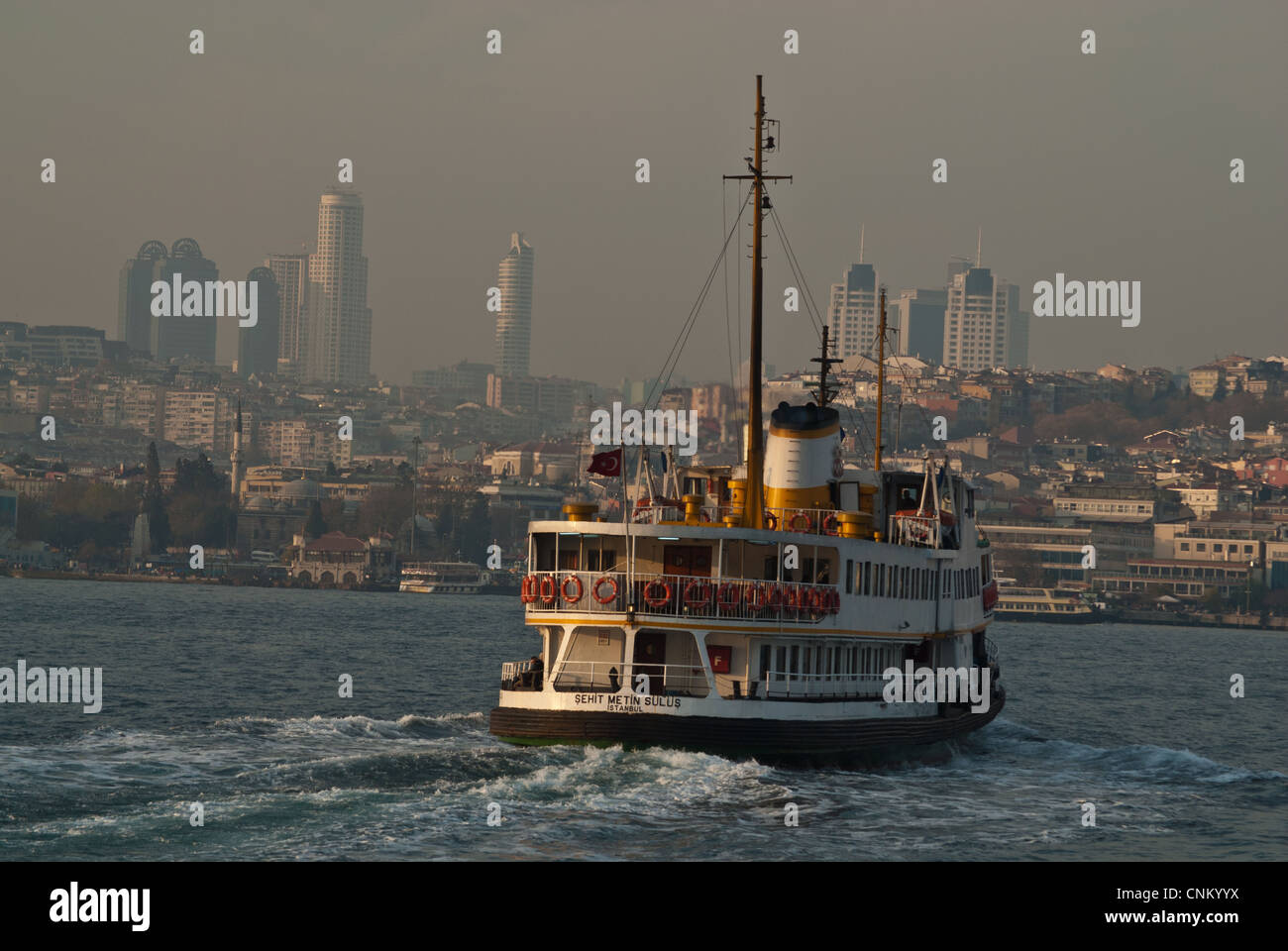 Passenger ferry crossing Bosphrous with Galatasaray High rises, Istanbul, Turkey Stock Photo
