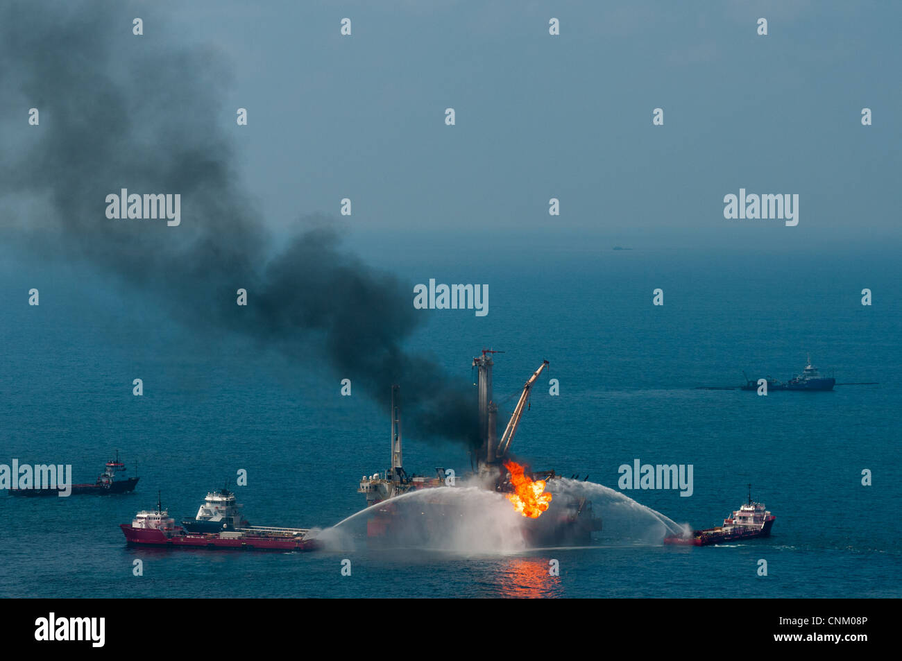 Helix Q4000 burning oil at the MC252 (Mississippi Canyon Block 252) site, Gulf of Mexico, Louisiana. The flame is 75-100 feet. Stock Photo