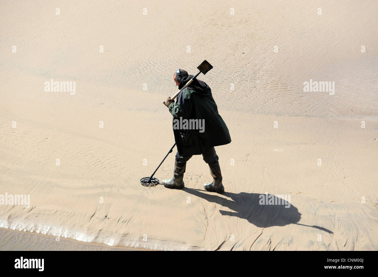 Man using metal detector on the beach at Blackpool England Uk Stock