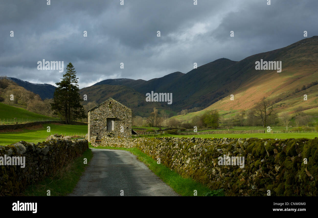 Road and barn in Troutbeck valley, Lake District National Park, Cumbria England uk Stock Photo
