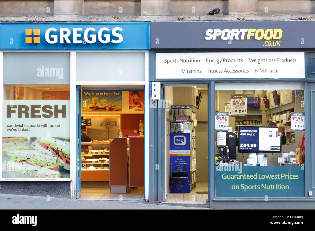 This Sport food shop is permanently closed. Greggs takeaway next door to a Sportfood shop, Scotland, UK. Stock Photo