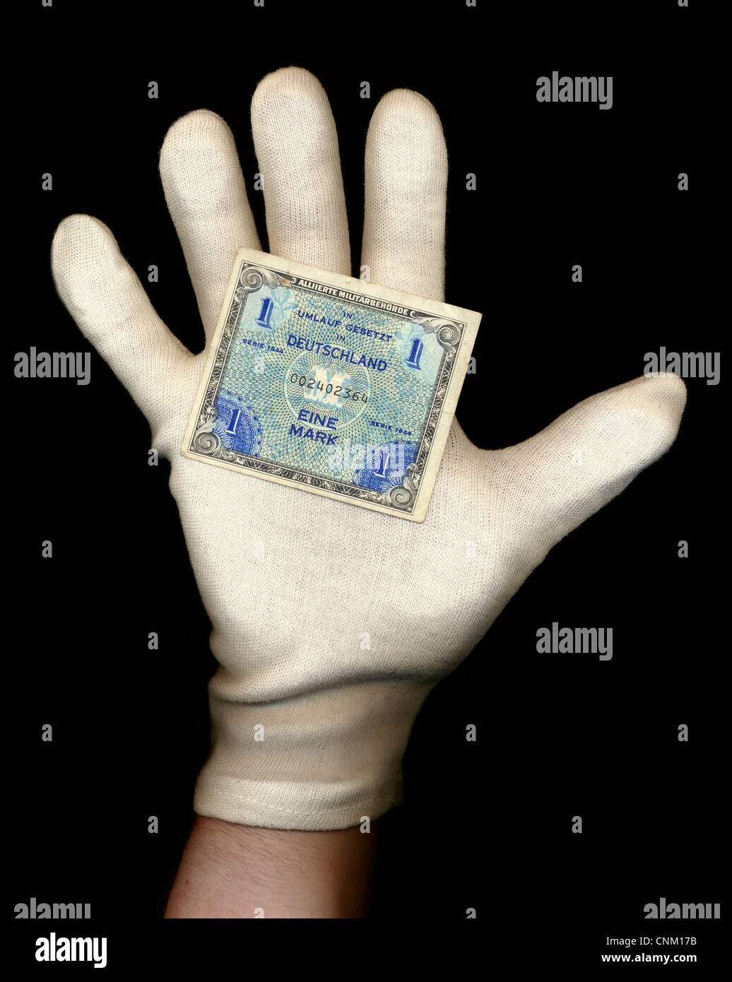 A hand with a white glove holds a banknote, Reichsbank, Allied Occupation, value 1 Mark, 1944, Germany, Europe , Stock Photo