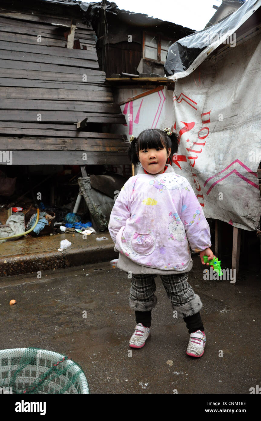 Chinese girl with a toy gun Stock Photo