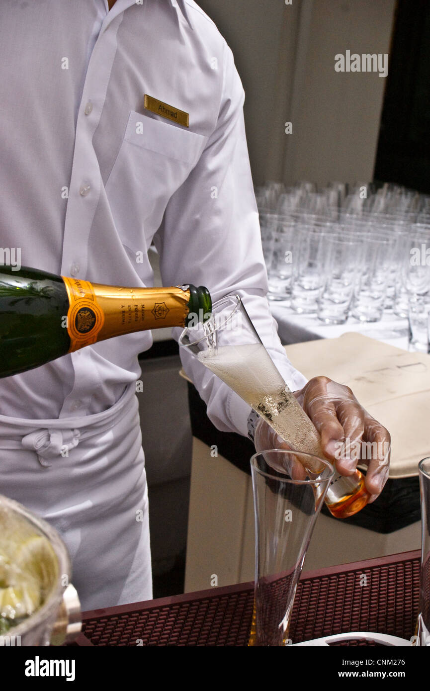 A barman pours Veuve Clicquot champagne at Friday Brunch at Park Hyatt Hotel, Dubai Creek, Dubai, United Arab Emirates Stock Photo