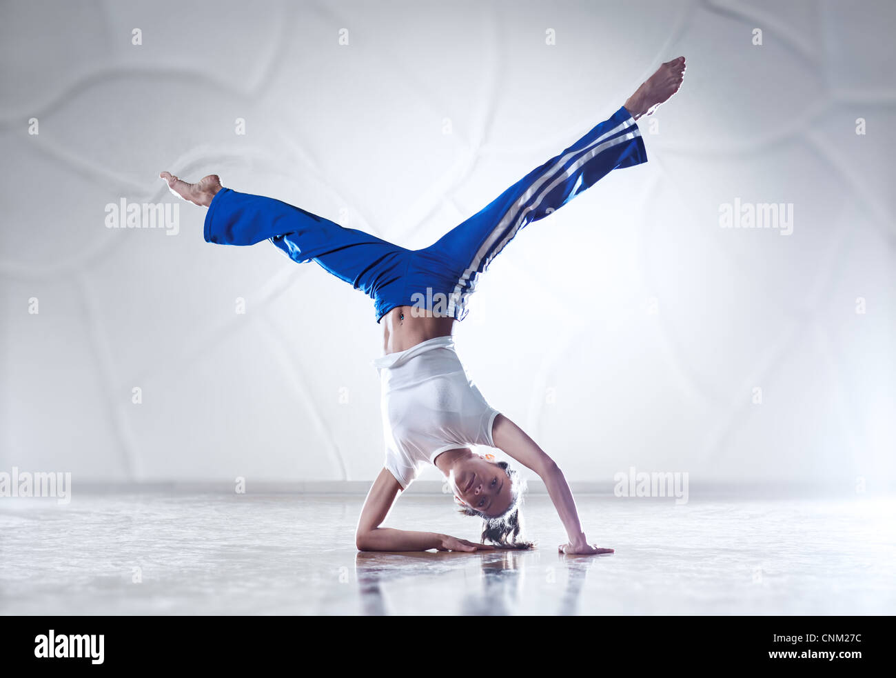 Young woman gymnast. Bright white colors. Stock Photo