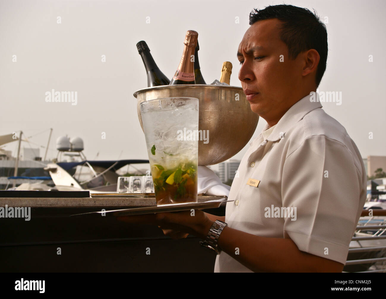 A waiter with a jug of rum cocktail at Friday Brunch at Park Hyatt