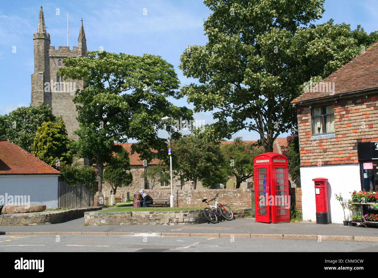 church and red telephone box Lydd Kent England UK Stock Photo