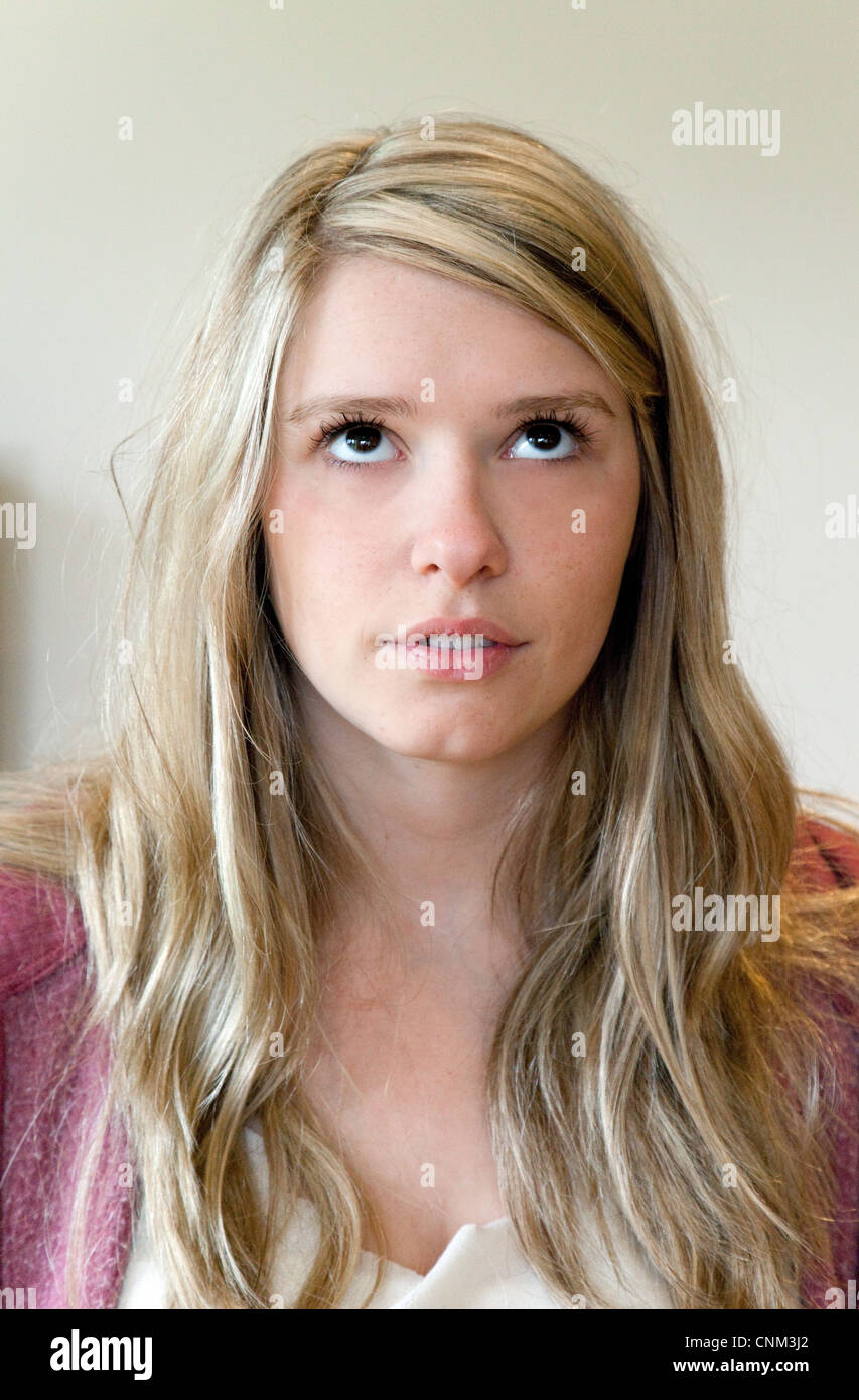 Young blonde woman looking up, and rolling eyes, UK Stock Photo Alamy