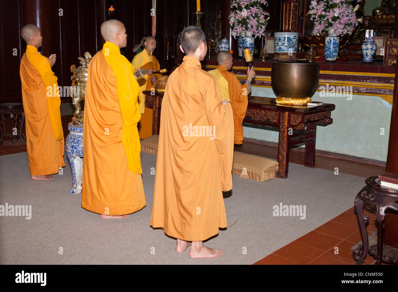 Buddhist monks praying inside the temple, Thien Mu Pagoda, Hue, Vietnam