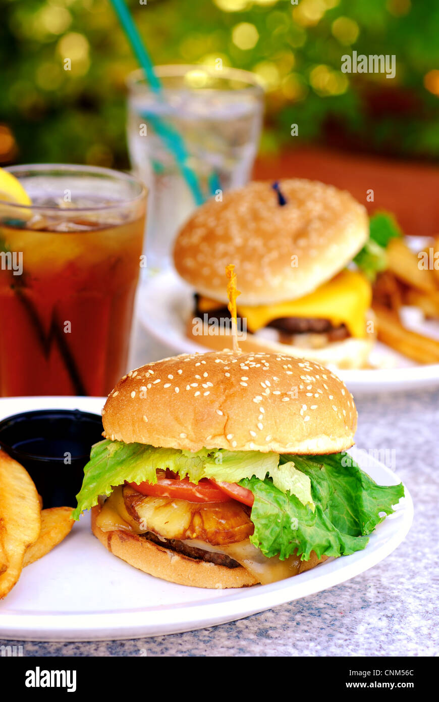 Teriyaki burger with large French fries at an outdoor restaurant Stock Photo