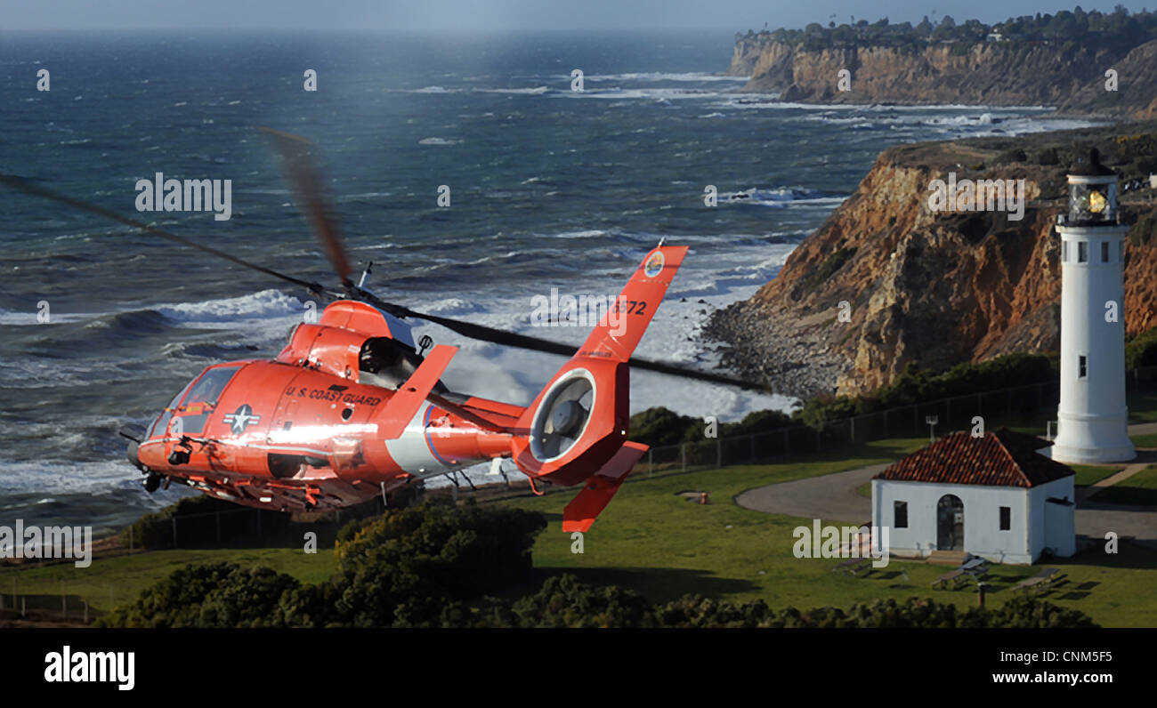 US Coast Guard Dolphin helicopter crew assigned conducts a flyover of the Point Vicente Lighthouse as part of the memorial service for fallen comrades March 18, 2012, in Los Angeles, CA. Stock Photo