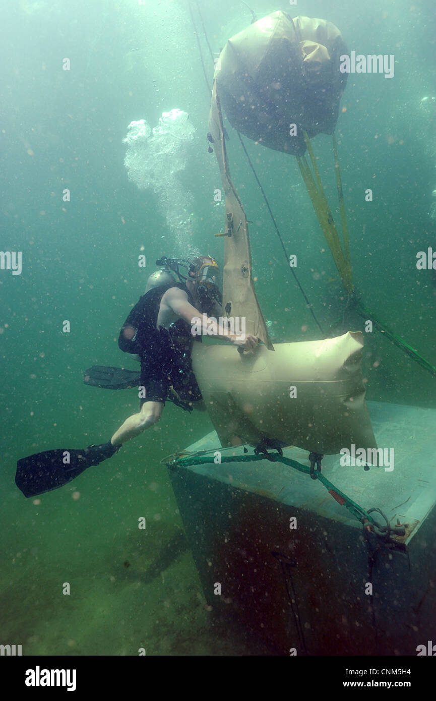 US Navy Divers assigned to the Mobile Diving and Salvage Unit hooks a lift bag to an object April 3, 2012, in the Caribbean Sea. Stock Photo