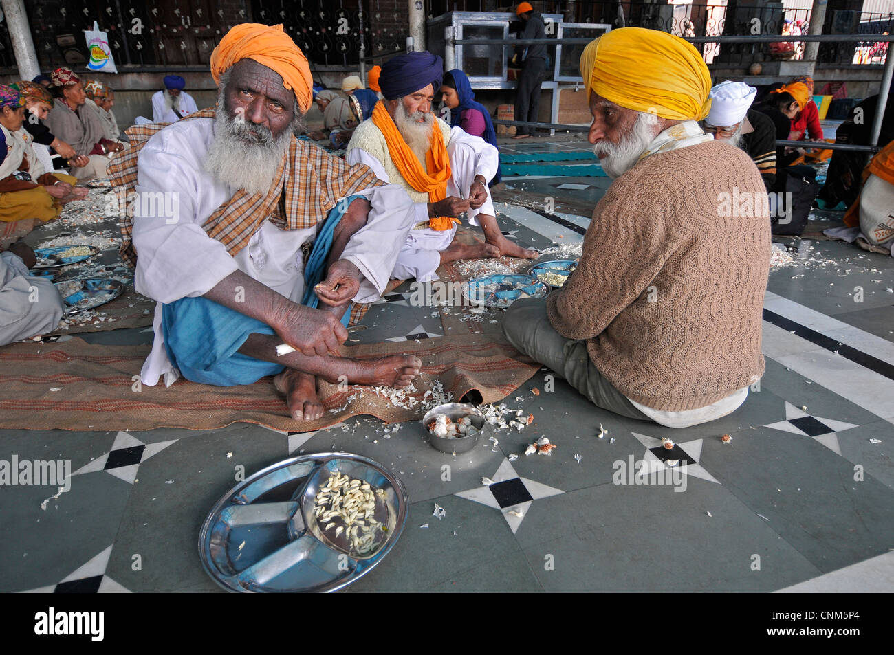 Asia India Punjab Amritsar Golden Temple or Hari Mandir Volunteers prepare food to be consumed by the faithful Stock Photo