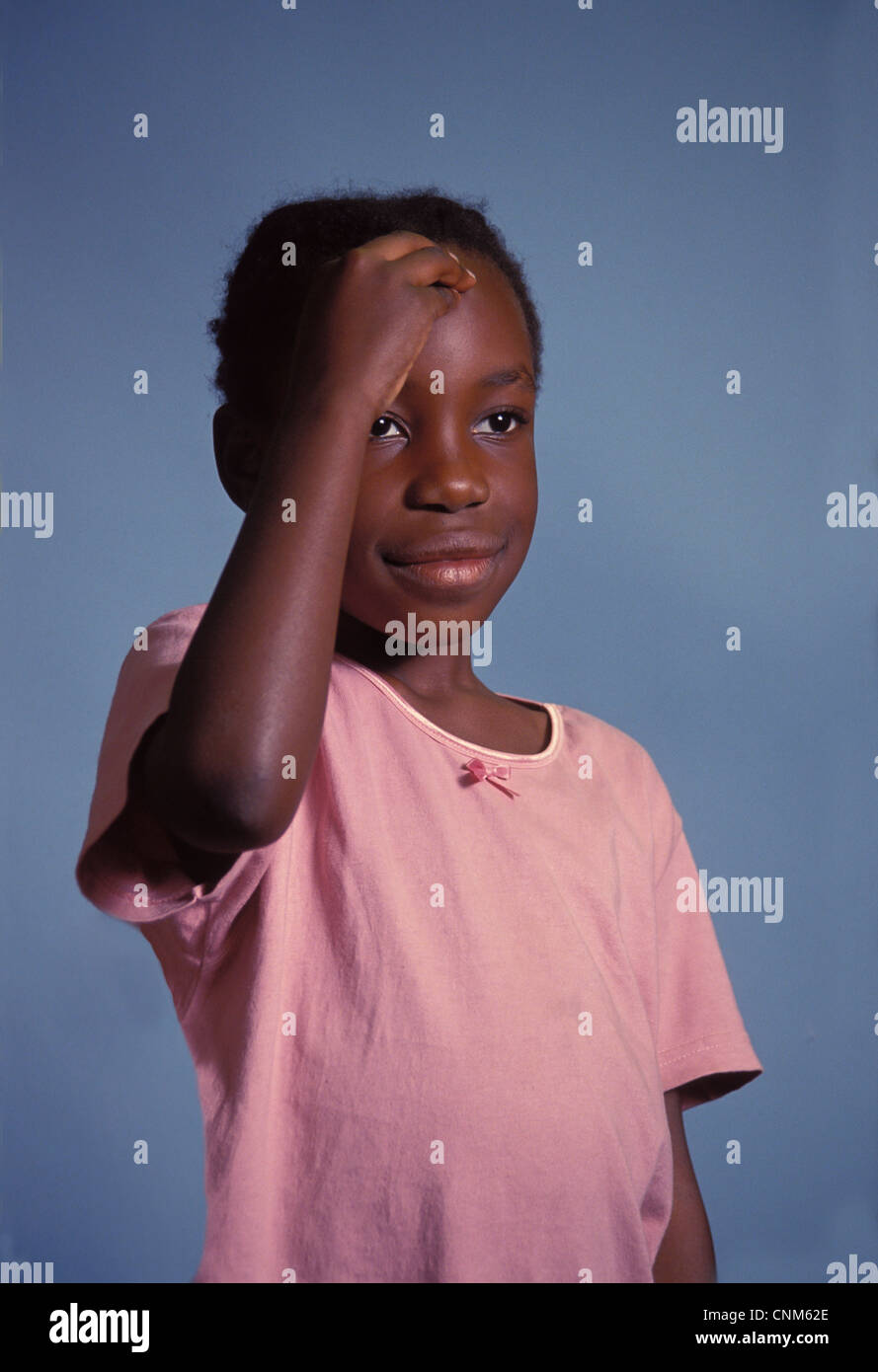 girl Child making sign of the cross on her forehead in Catholic Church