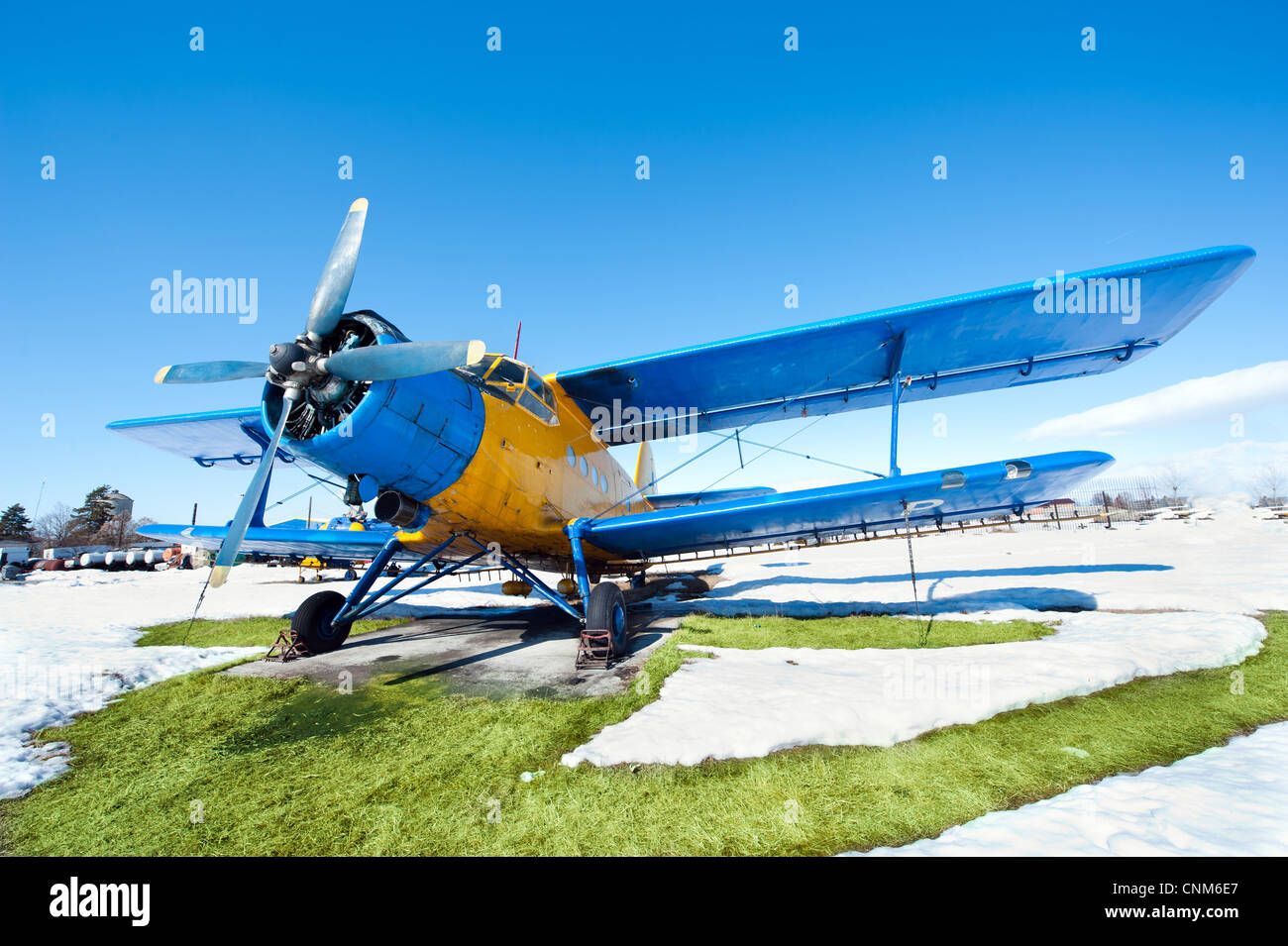 Old airplanes parked on a meadow with snow in a sunny day Stock Photo ...
