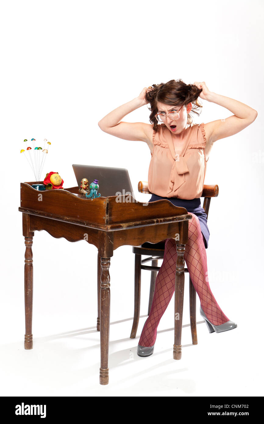 A woman in retro clothing sits at a vintage desk with a look of