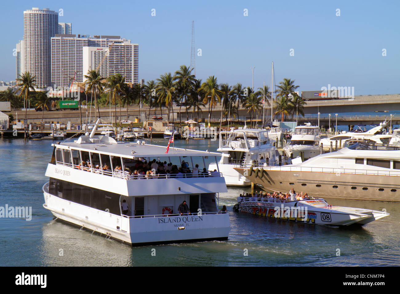 Miami Florida,Bay waterside Marketplace,Marina,Biscayne Bay water,Island Queen,tour boat,Thriller speedboat,Port Boulevard Bridge,visitors travel trav Stock Photo