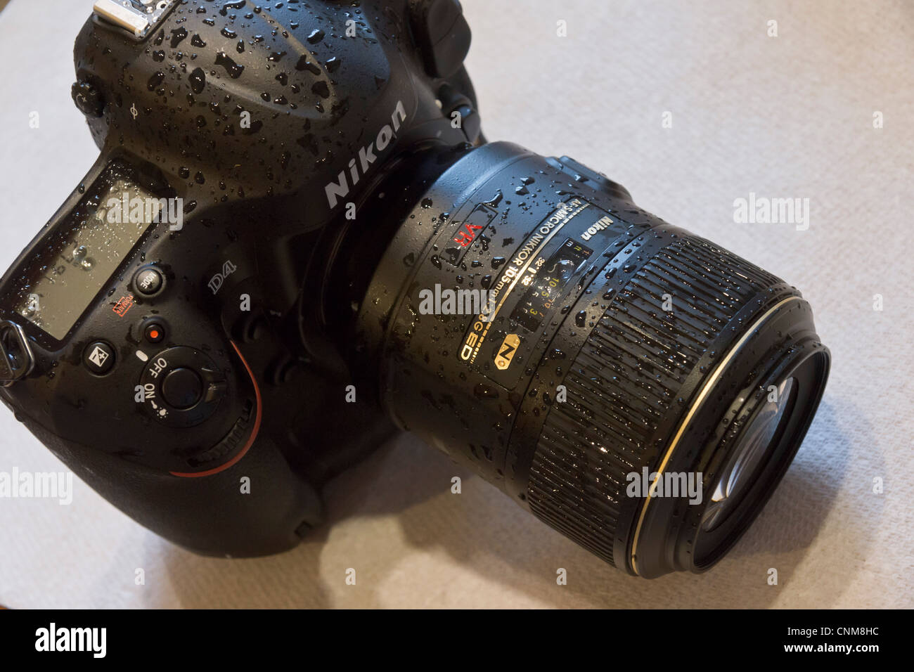 Photographic equipment - Nikon D4 wet from rain - waterproof lens and body. Stock Photo