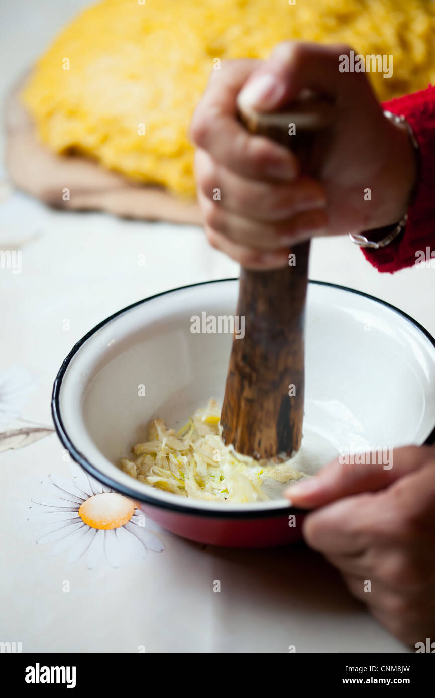 Woman hands crushing raw garlic in a bowl Stock Photo Alamy