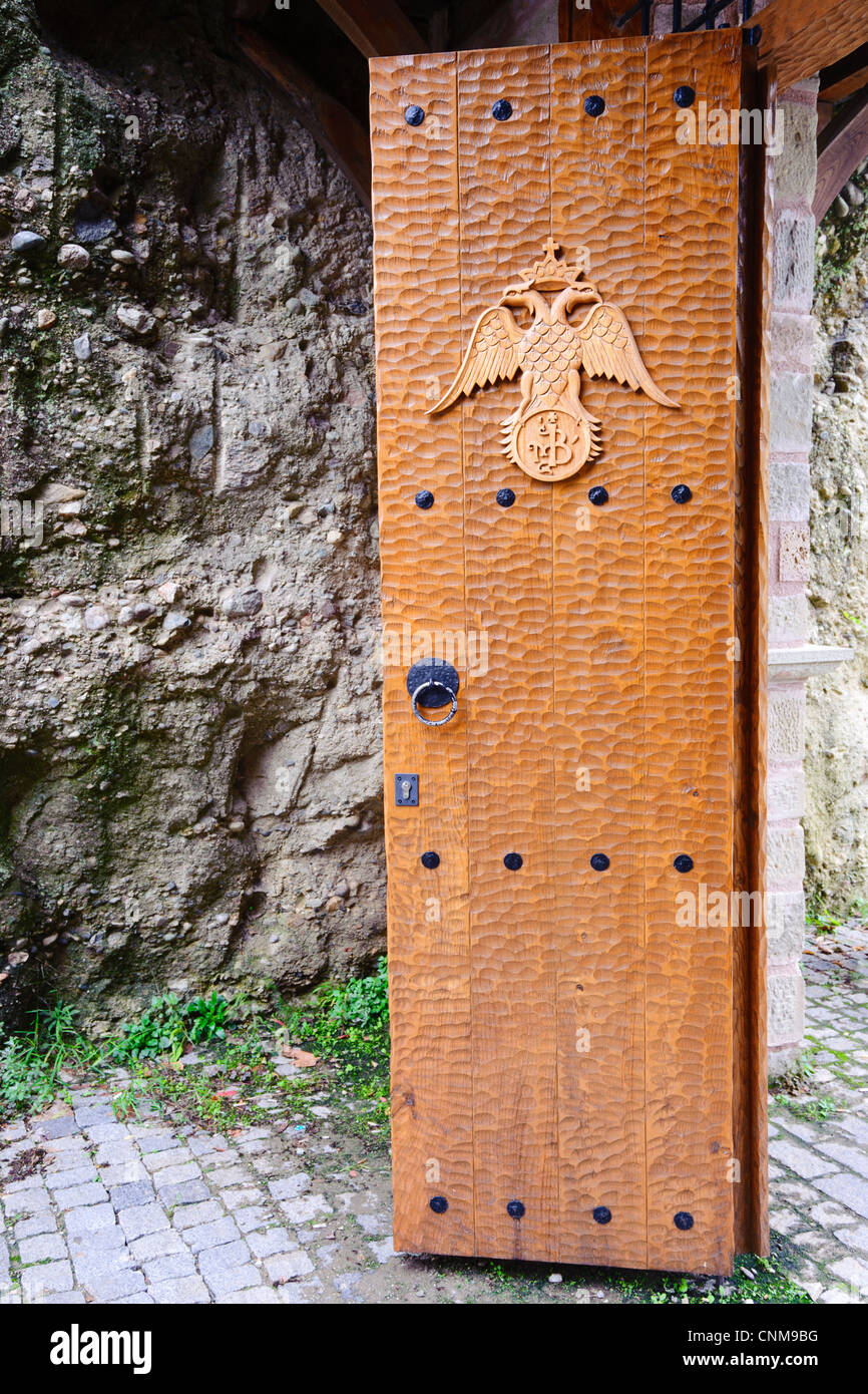 Chiseled wooden door leading to Varlaam monastery. The coat of arms is