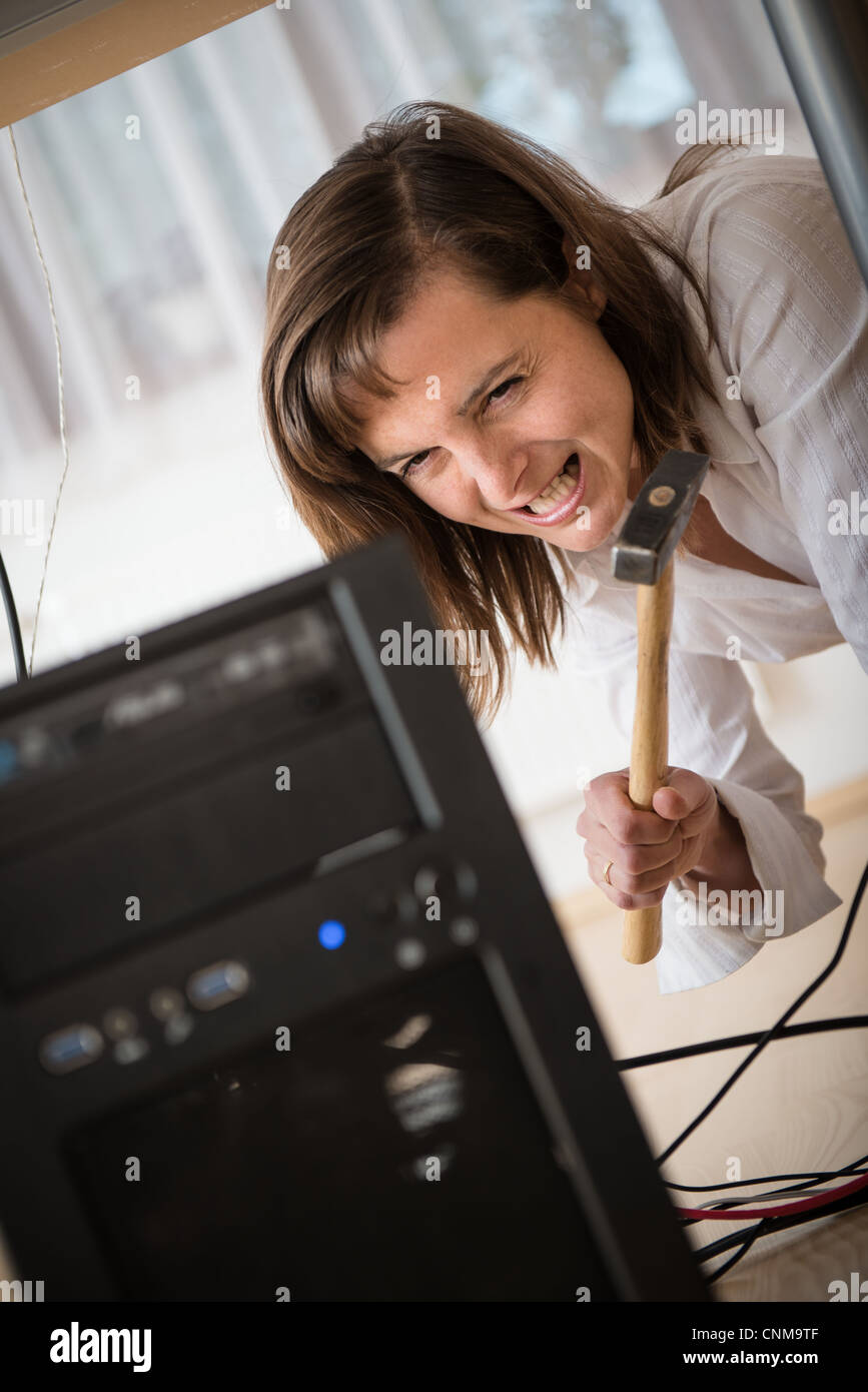 Young business woman having problem with computer and trying to recover ...
