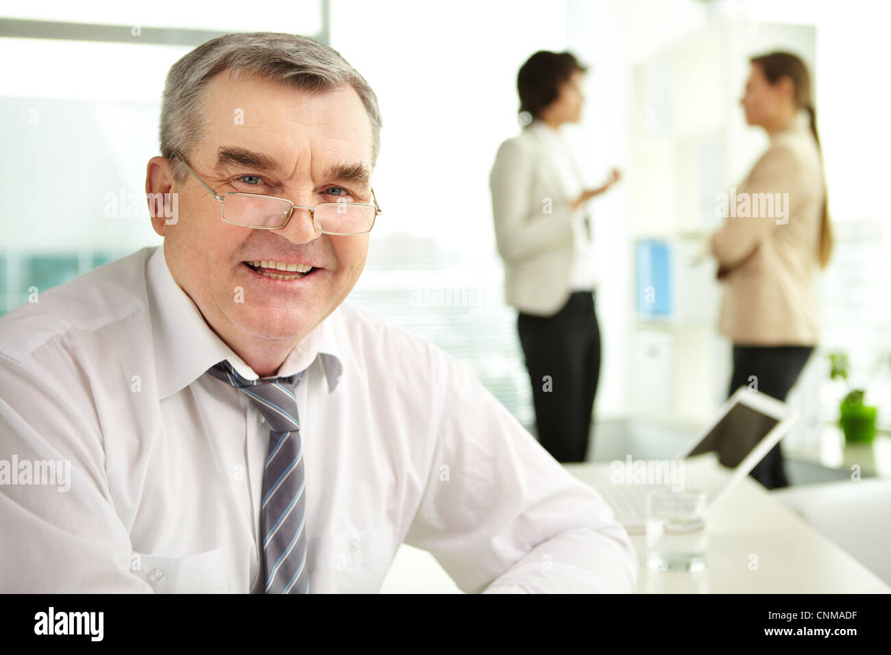 Mature businessman looking at camera in working environment Stock Photo ...