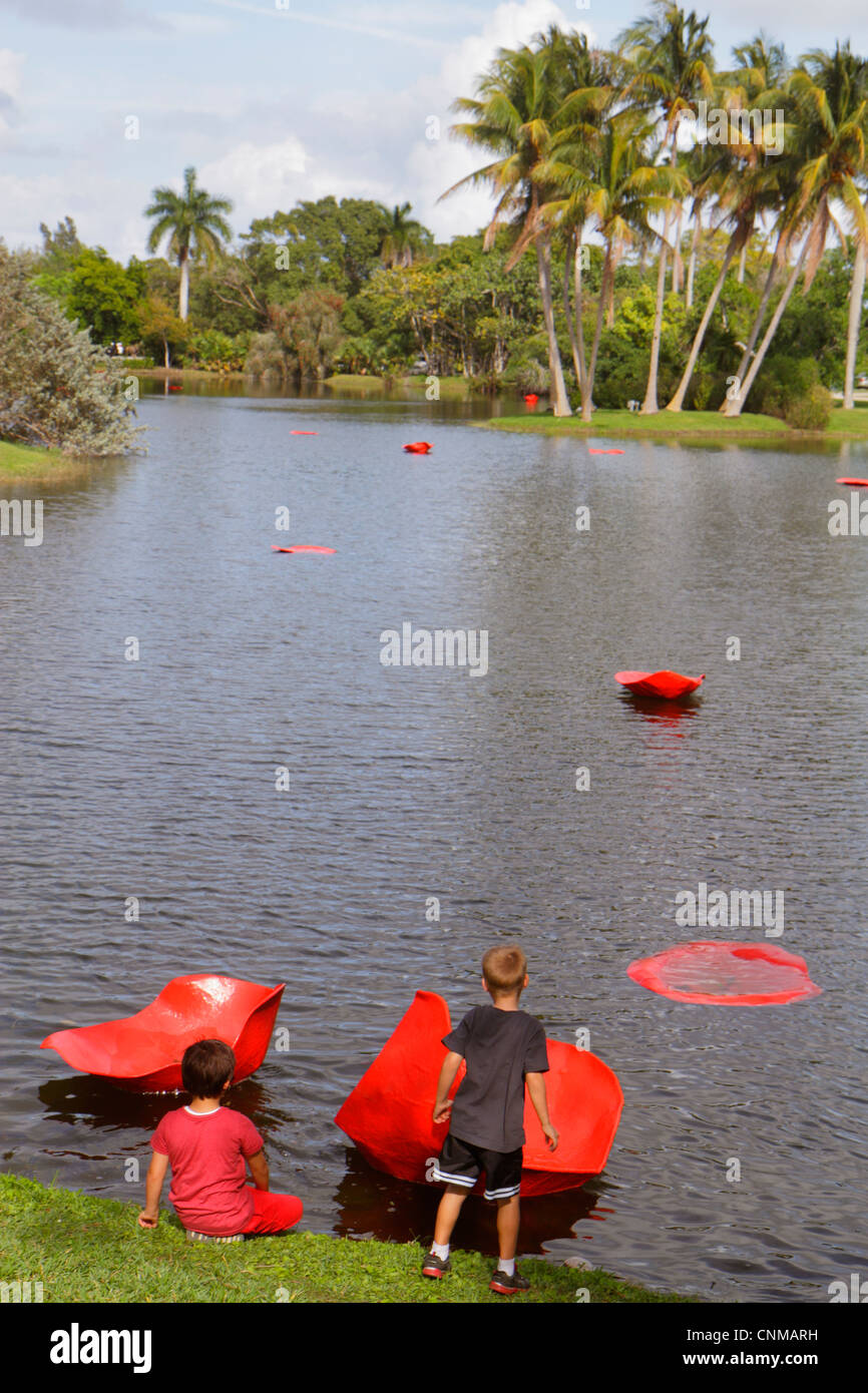 Miami Florida,Coral Gables,Fairchild Tropical Gardens,giant red floating rose petals,art installation,artist Will Ryman,boy boys,male kid kids child c Stock Photo