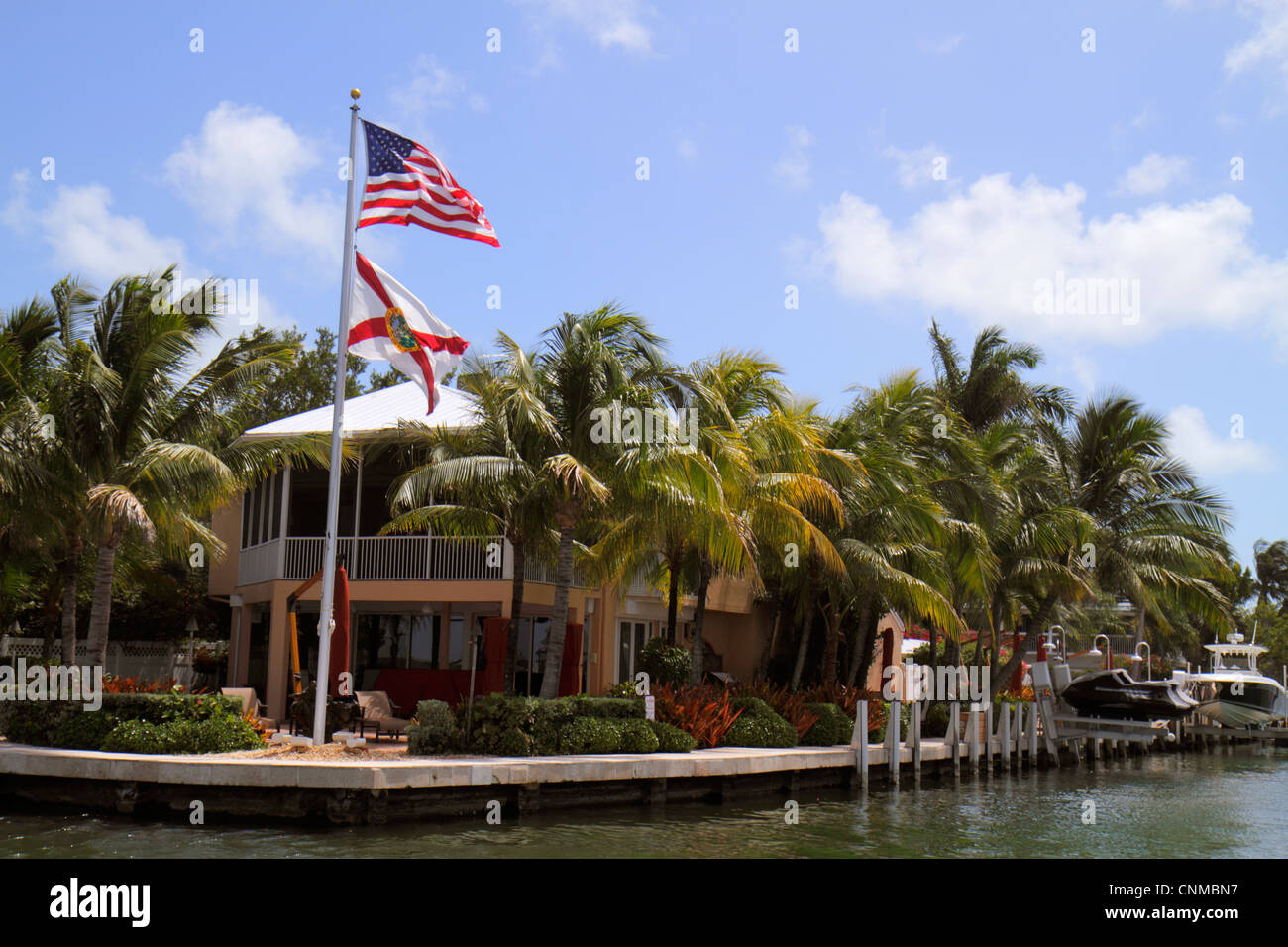 Florida Upper Key Largo Florida Keys,Blackwater Sound,Florida Bay,waterfront homes,houses,palm trees,flag,flagpole,FL120331034 Stock Photo