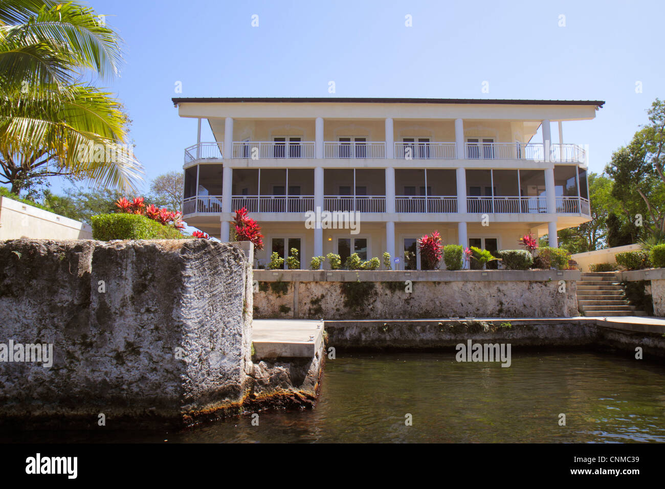 Florida Upper Key Largo Florida Keys,Largo Sound Canal,waterfront homes,houses,palm trees,coralline limestone late Pleistocene reef complex,FL12033105 Stock Photo