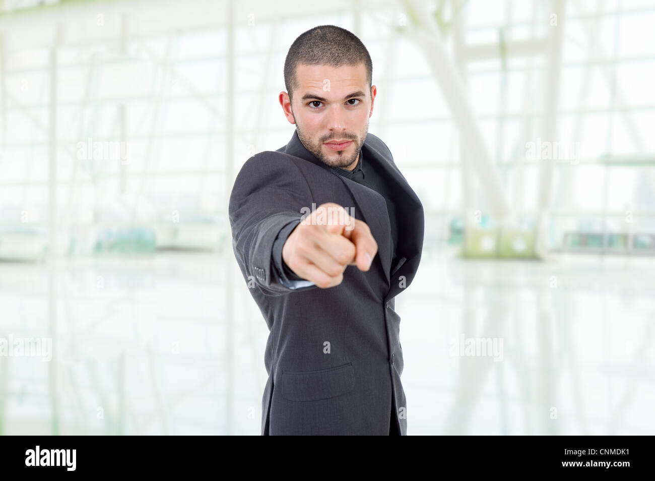young business man in a suit pointing with his finger Stock Photo - Alamy