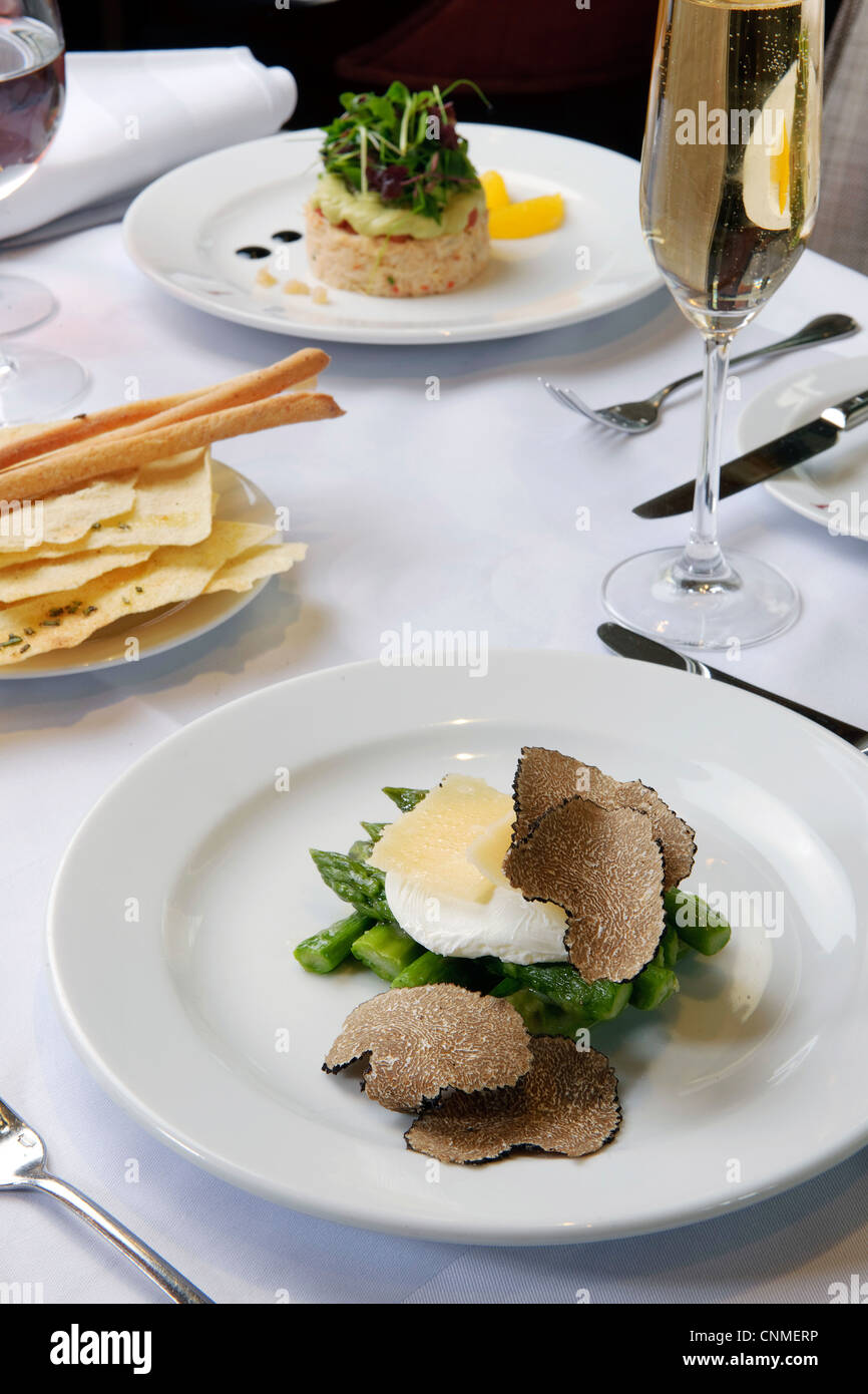 asparagus and truffles in meal on white restaurant table Stock Photo