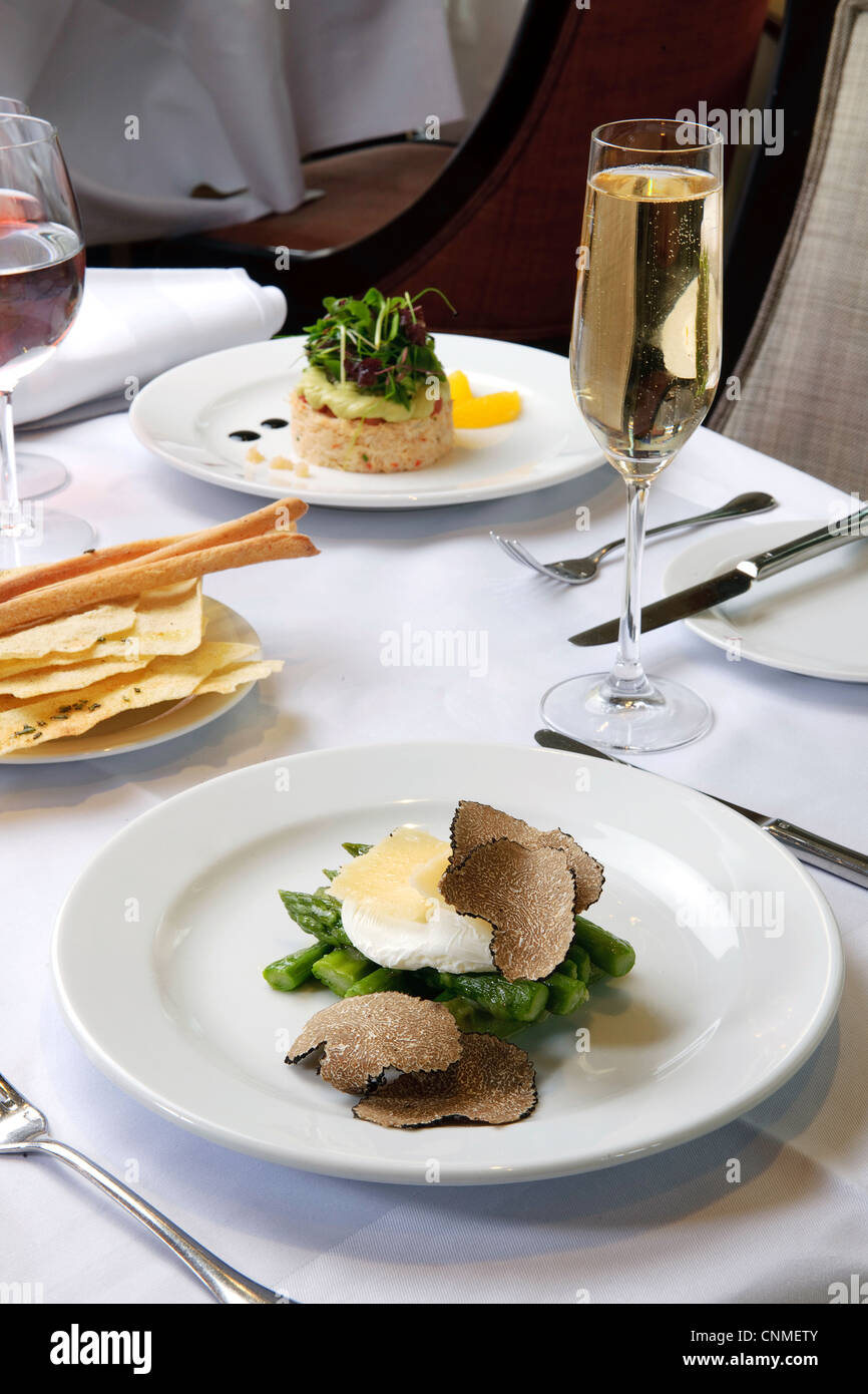 asparagus and truffles in meal on white restaurant table Stock Photo
