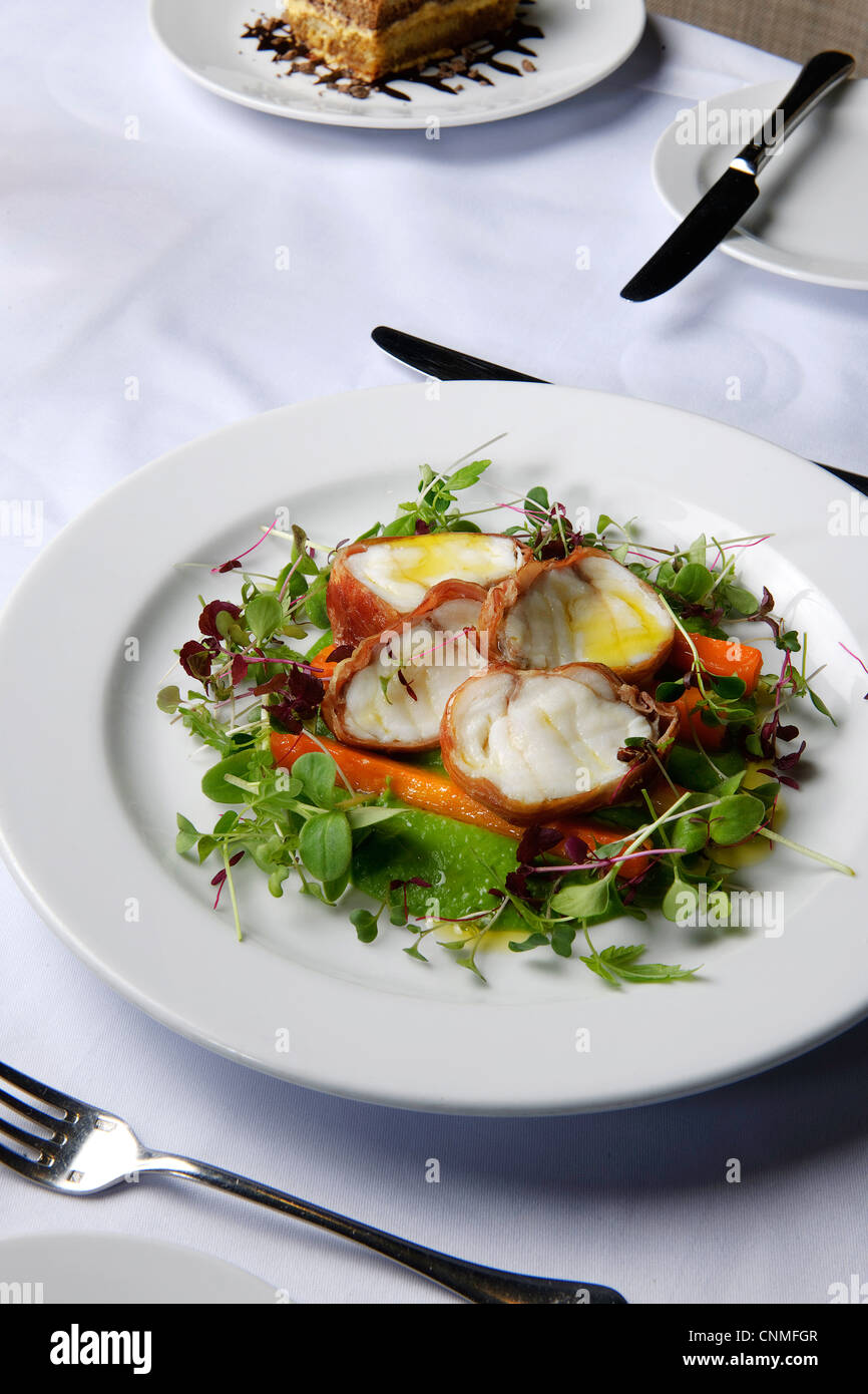 white plate on restaurant table of fish salad Stock Photo