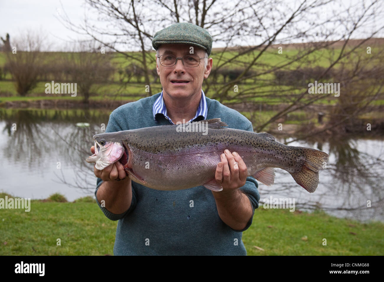 Trout fisherman with a large 11lb 10oz (5.4Kg) rainbow trout fish