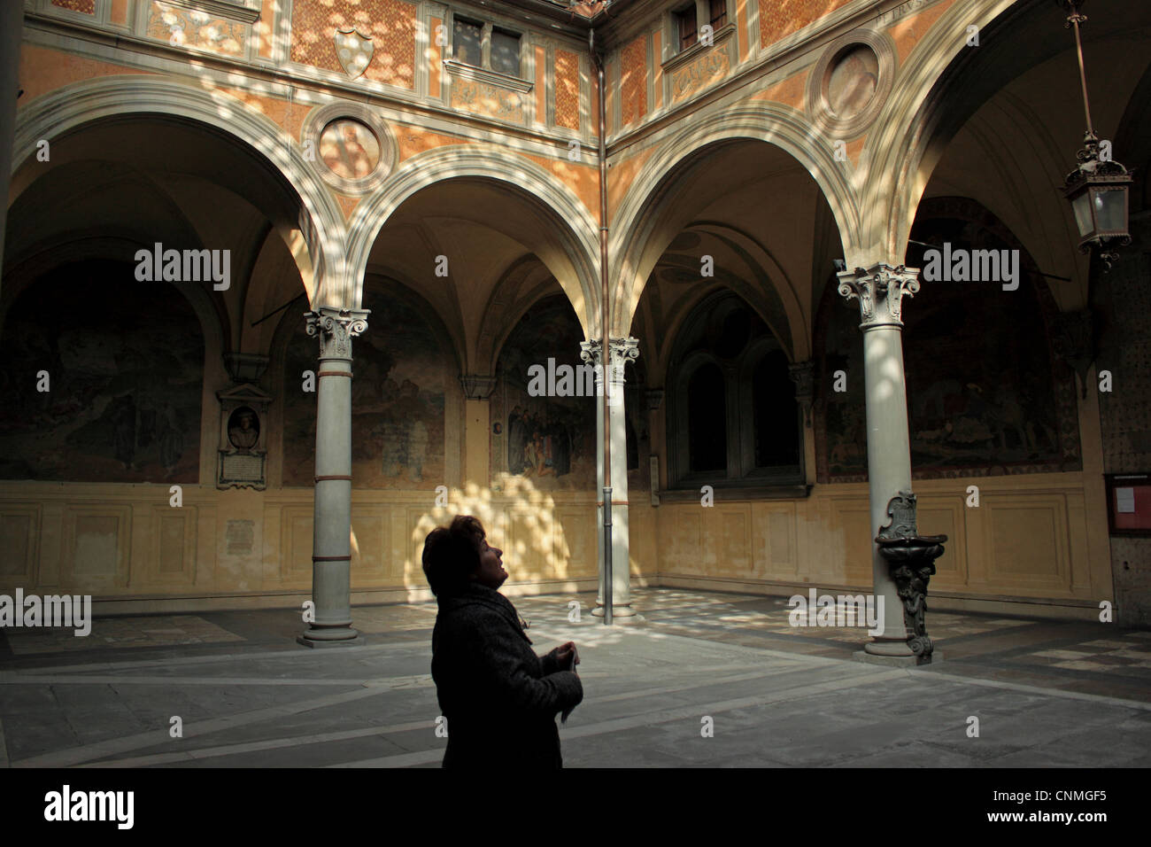 A woman visits the Basilica della Santissima Annunziata en Florence, Italy, February 27, 2012. Stock Photo