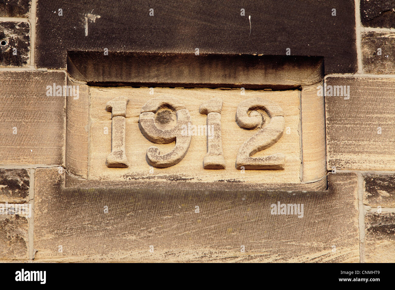 Year 1912 carved in stone on the exterior wall of a building, UK Stock Photo