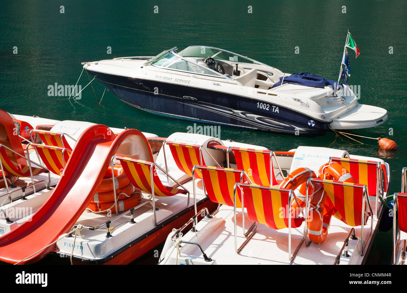 Speed boat and pedalos on Lake Garda, Italy Stock Photo