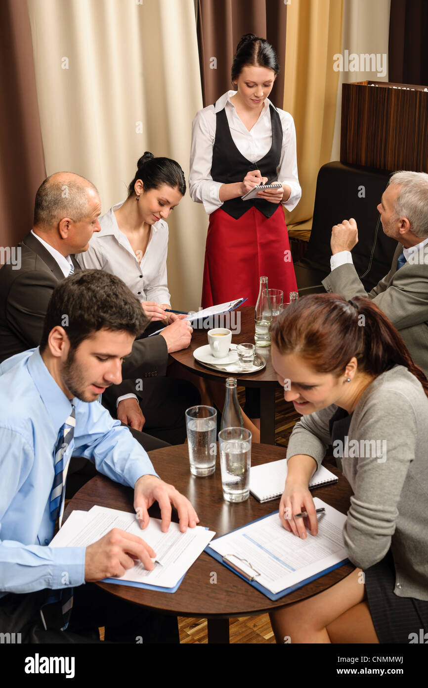 Business people have company meeting at restaurant waitress ordering Stock Photo