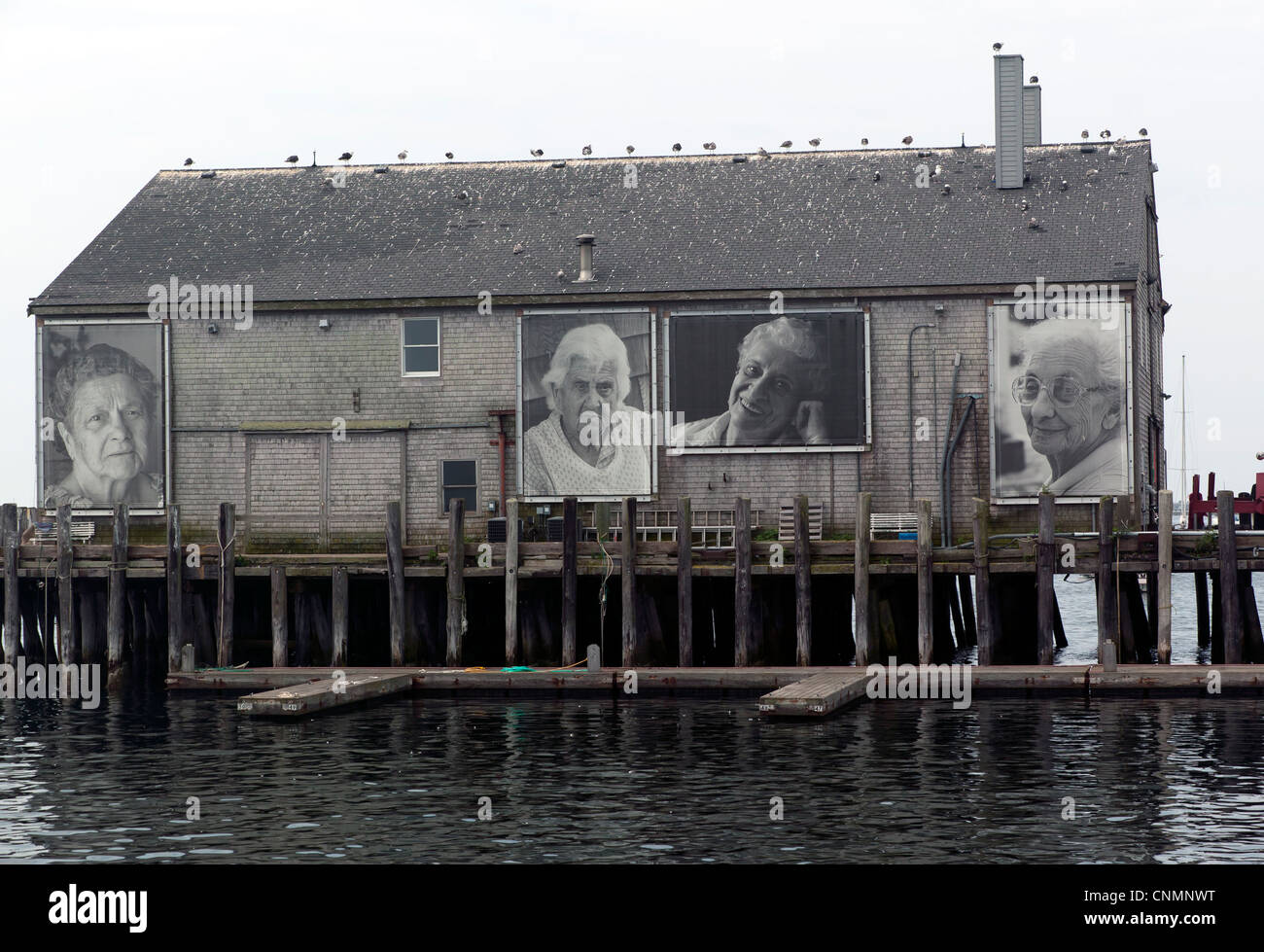 Black and White portrait photographs on a building at Fishermans Wharf, Provincetown, Cape Cod, Massachusetts, USA Stock Photo