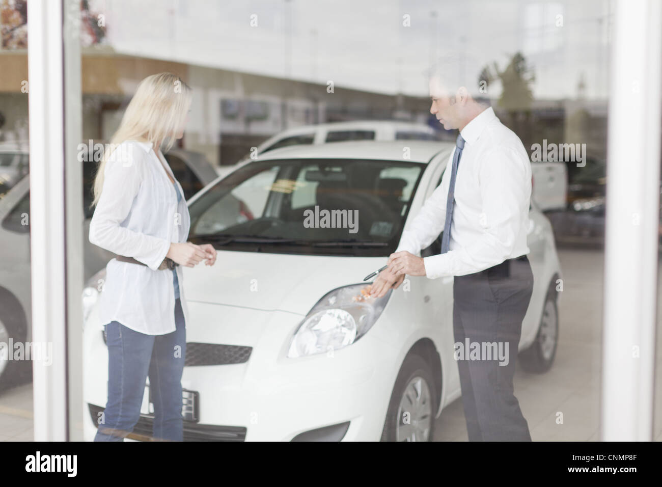 Car salesman showing car to customer Stock Photo Alamy