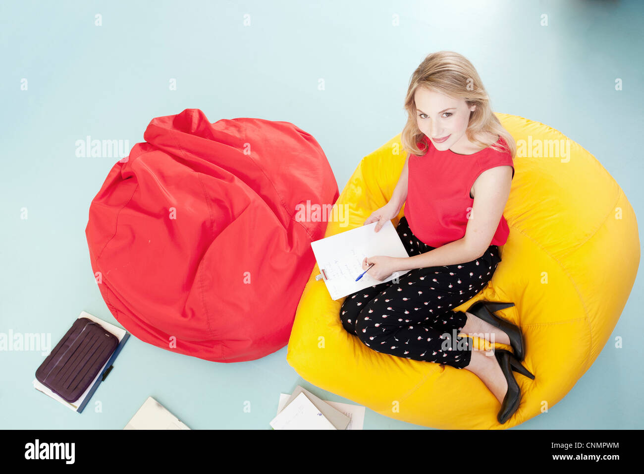 Businesswoman working in bean bag chair Stock Photo Alamy