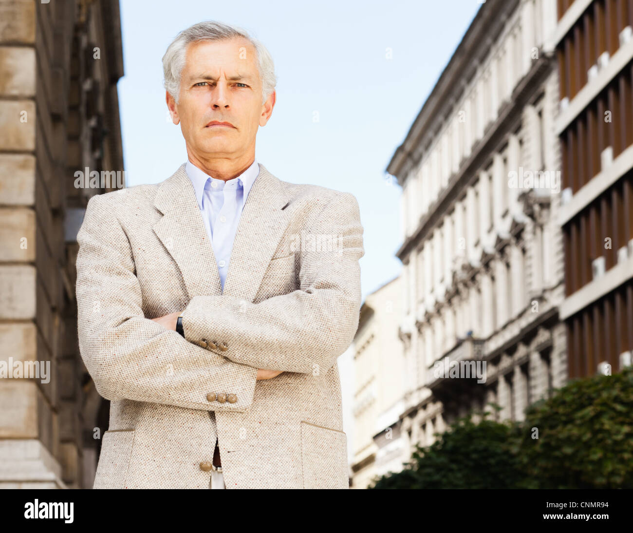 Businessman standing with arms crossed Stock Photo