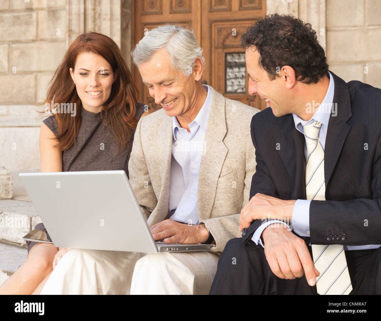 Business people working on stone steps Stock Photo