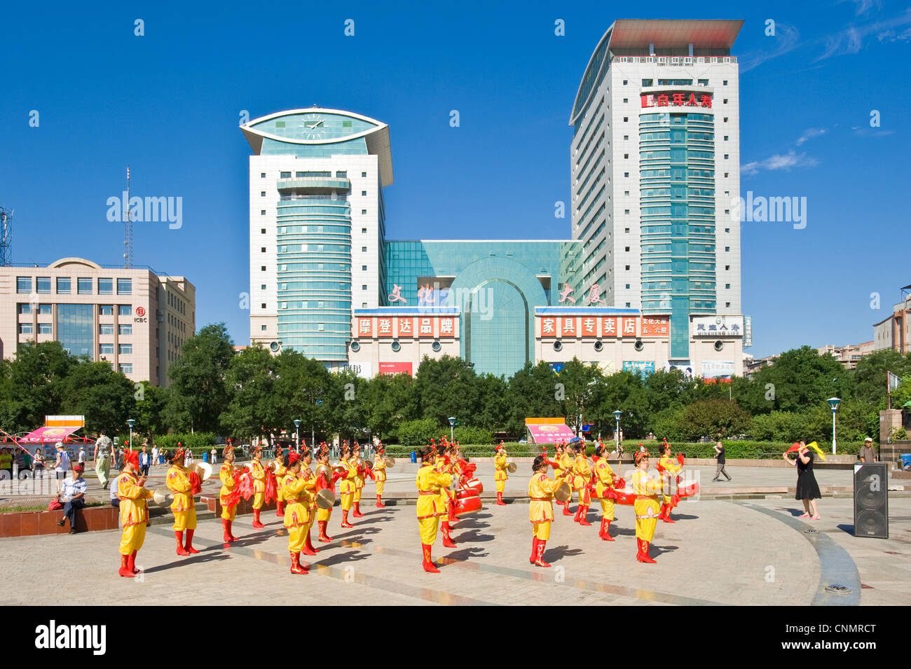 The city square in Chengde with a group of local women playing traditional music and wearing traditional clothes. Stock Photo