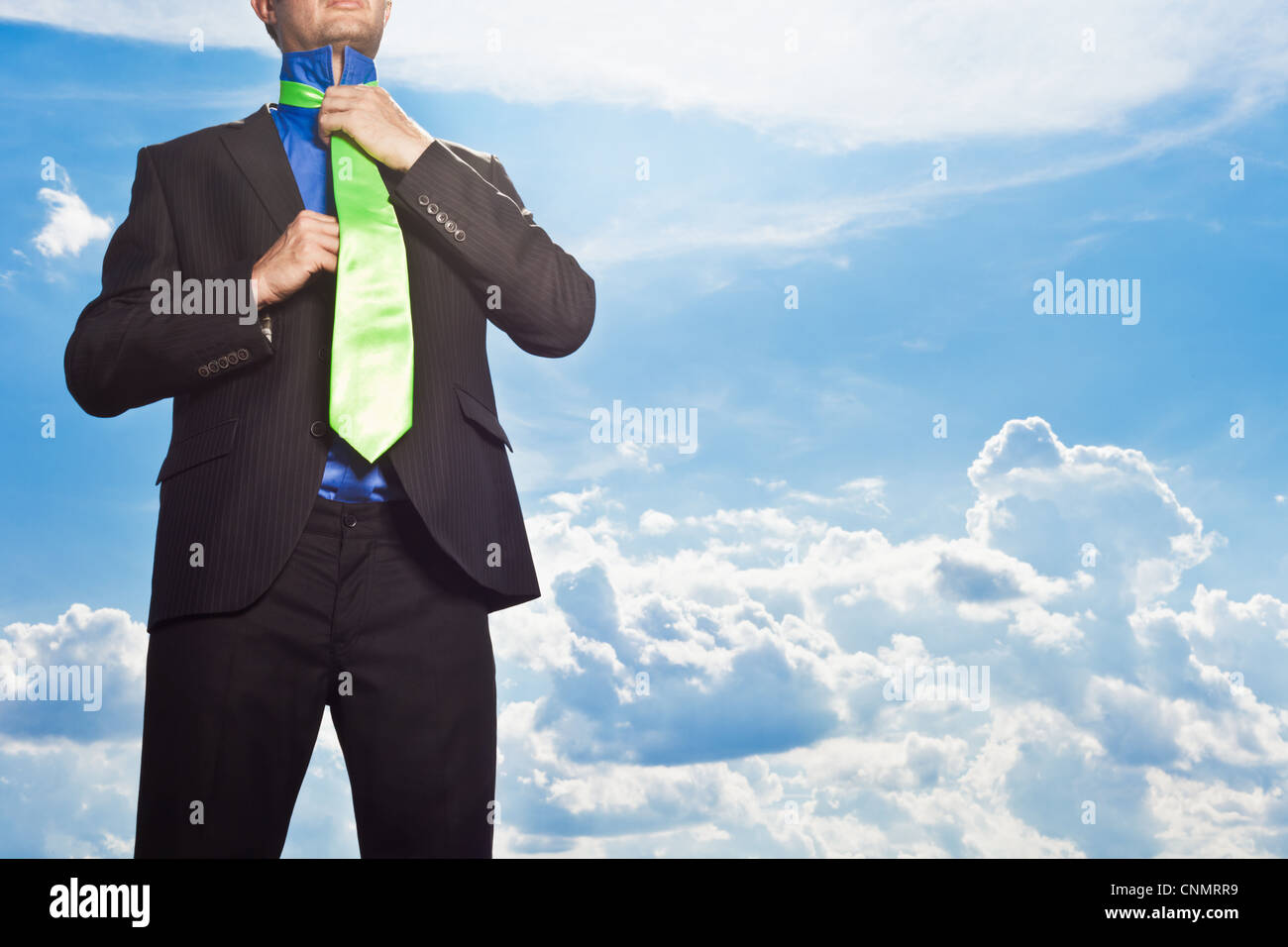 Businessman tying his tie outdoors Stock Photo