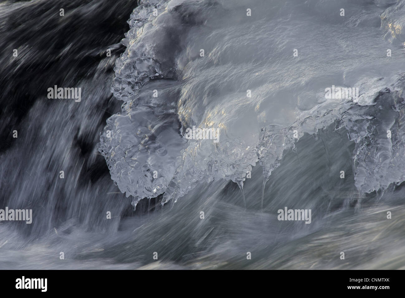 Flowing water and ice on partially frozen river, River Nith, Dumfries and Galloway, Scotland, december Stock Photo