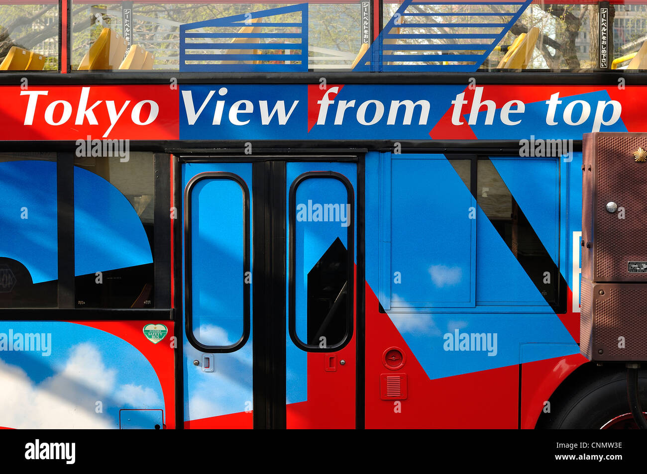 Side view of red/blue Tokyo sightseeing (double-decker) bus with 